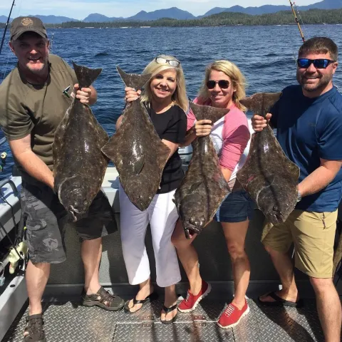 Maricel Presilla et al. posing for a fish in the water