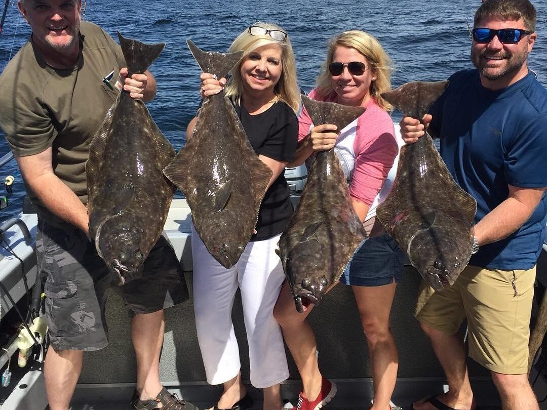 Maricel Presilla et al. posing for a fish in the water