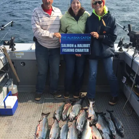 a man holding a fish on a boat