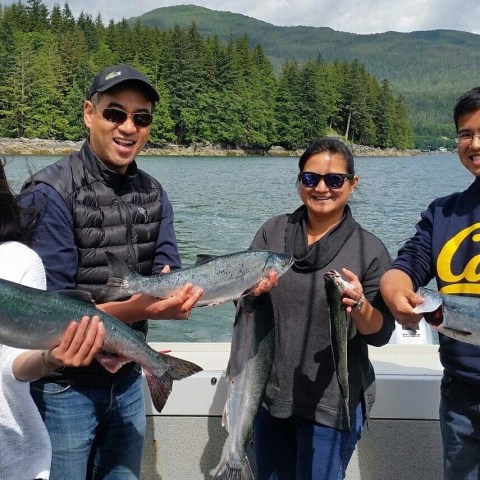 guys taking a picture with a fish in hand